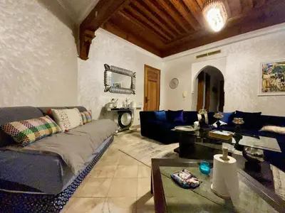 a living room with a couch and a table at Au Temps Des Fleurs - Marrakech in Marrakech
