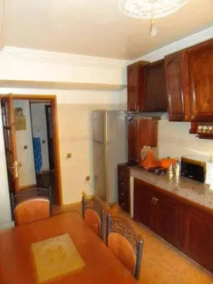 a kitchen with a table and chairs and a refrigerator at Manis Apartment Set in a Hotel Area in Marrakech