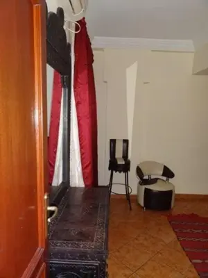 a living room with a table and a chair at Manis Apartment Set in a Hotel Area in Marrakech