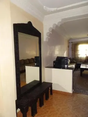 a mirror on a wall in a living room at Manis Apartment Set in a Hotel Area in Marrakech