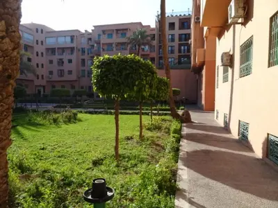 a park with trees in the middle of a building at Manis Apartment Set in a Hotel Area in Marrakech