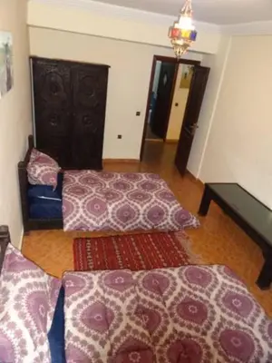 a living room with two beds and a rug at Manis Apartment Set in a Hotel Area in Marrakech