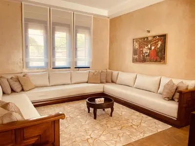 a living room with a couch and a table at Villa Talmoulkt Familiale in Marrakech