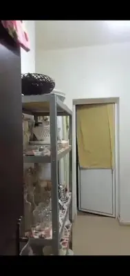 a kitchen with a shelf with dishes and a window at Samlalia home in Marrakech