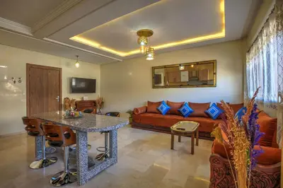 a living room with a couch and a table at Nour 5 el bellar in Marrakech