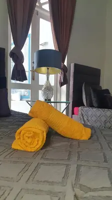 a yellow blanket on a bed next to a lamp at Riad VIP Bed & Breakfast in Marrakech