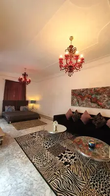 a living room with a couch and a chandelier at Riad VIP Bed & Breakfast in Marrakech