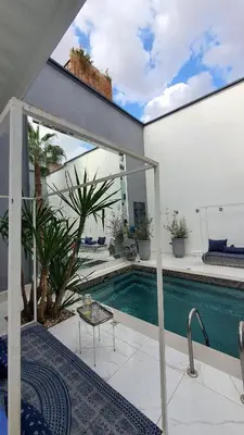 a house with a swimming pool and a patio at Riad VIP Bed & Breakfast in Marrakech