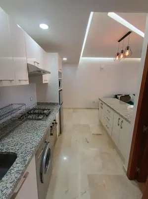a kitchen with a sink and a stove top oven at appartement en résidence in Marrakech