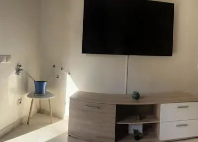 a living room with a tv on the wall at appartement génial in Marrakech