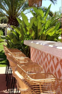 two wicker chairs sitting next to a table with plants at Maison Kenoosha Boutique Hotel & Spa in Marrakech