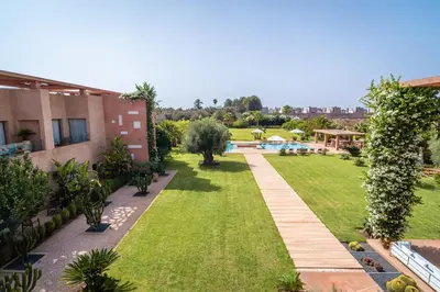 an image of a garden with a swimming pool at Maison Kenoosha Boutique Hotel & Spa in Marrakech