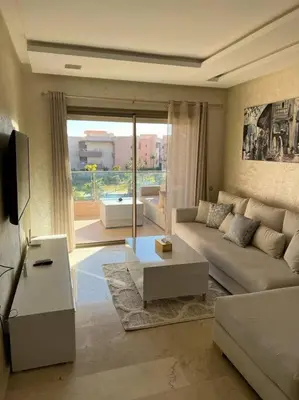 a living room with a couch and a large window at Beautiful apartment in Golf City Marrakech in Marrakech
