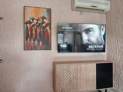 two posters of a movie on a wall with a tv at Babylone Marrakech in Marrakech