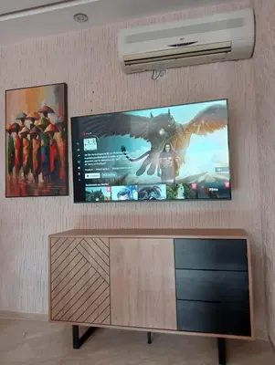 a flat screen tv hanging on a wall at Babylone Marrakech in Marrakech