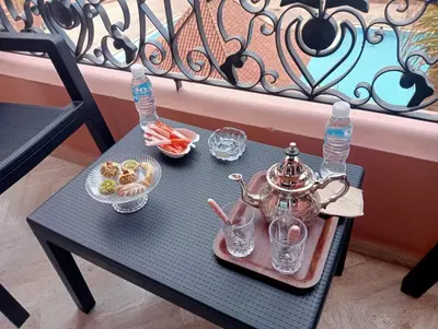 a table with a tea kettle and glasses on it at Babylone Marrakech in Marrakech