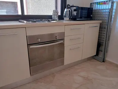 a kitchen with a sink and a stove top oven at Babylone Marrakech in Marrakech