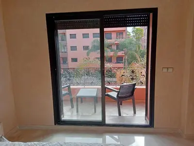 a room with a window with a table and chairs at Babylone Marrakech in Marrakech