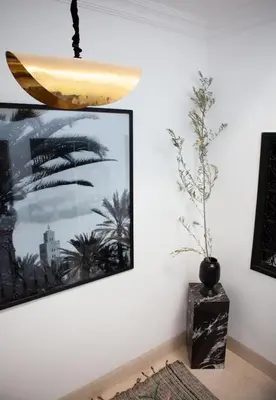 a room with a picture and a surfboard on the wall at Cosy Riad in Marrakech