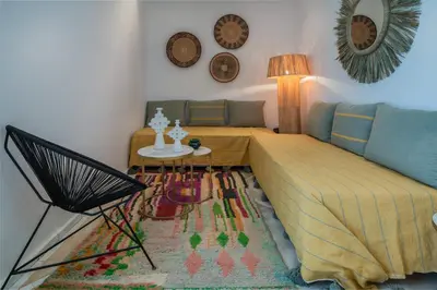 a living room with a bed and a table at Riad Kasbah El Mamoune in Marrakech