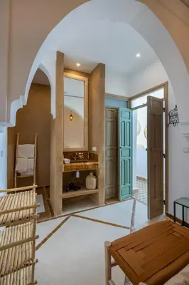 a room with a bathroom with a mirror and a table at Riad Kasbah El Mamoune in Marrakech