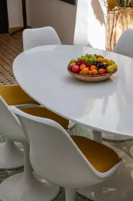 a white table with a bowl of fruit on it at Riad Kasbah El Mamoune in Marrakech