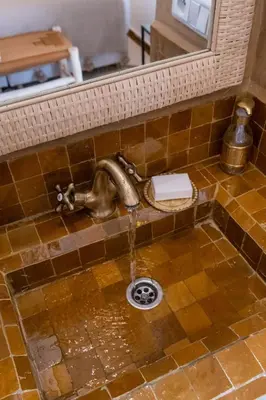 a bathroom sink with a water faucet at Riad Kasbah El Mamoune in Marrakech
