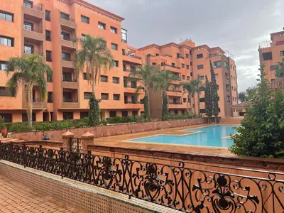 a swimming pool on a balcony of a building at Lovely Marrakech in Marrakech