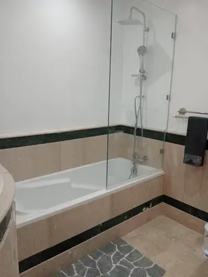 a bath tub with a glass shower in a bathroom at Lovely Marrakech in Marrakech