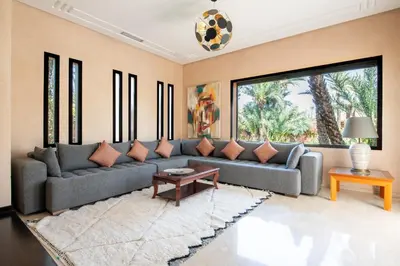 a living room with a couch and a table at Villa les Palmiers in Marrakech