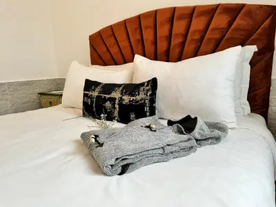 a white bed with a blanket and pillows on it at Riad Arrahma in Marrakech