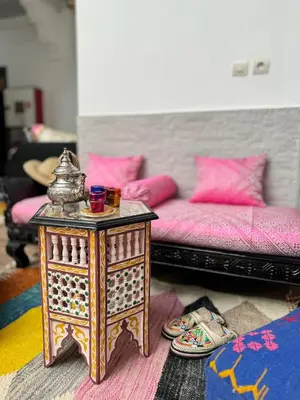 a living room with a table and a couch at Riad Arrahma in Marrakech