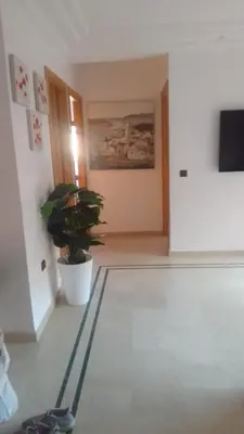 a hallway with a potted plant in a room at APPARTEMENT JAWHARA HIVERNAGE in Marrakech