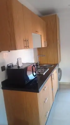 a kitchen with a sink and a counter top at APPARTEMENT JAWHARA HIVERNAGE in Marrakech