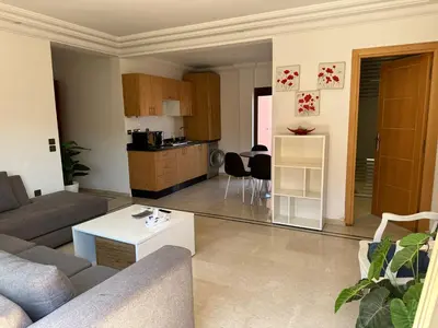 a living room with a couch and a table at APPARTEMENT JAWHARA HIVERNAGE in Marrakech