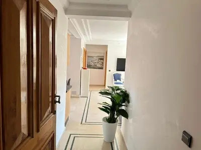 a hallway with a potted plant in a room at APPARTEMENT JAWHARA HIVERNAGE in Marrakech