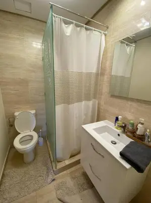 a bathroom with a toilet and a shower and a sink at Marrakech Prestigia Golf City - beauty Appartement in Marrakech