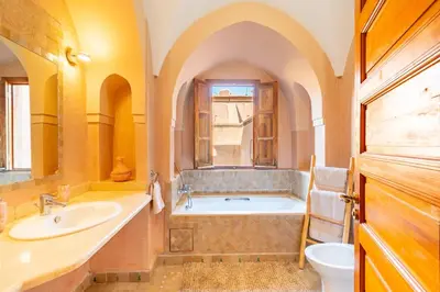 a bathroom with a tub and a sink at Villa les oliviers in Marrakech