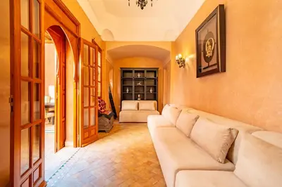a living room with a couch and a table at Villa les oliviers in Marrakech