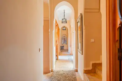 a hallway with an archway in a house at Villa les oliviers in Marrakech