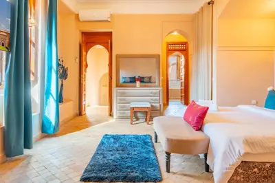 a bedroom with a bed and a couch at Villa les oliviers in Marrakech