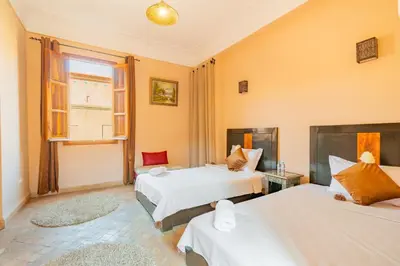 a bedroom with two beds and a window at Villa les oliviers in Marrakech