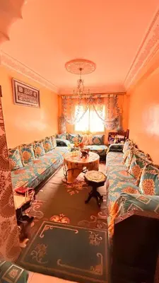 a living room with a couch and a table at WOLFY’s Apartment in Marrakech