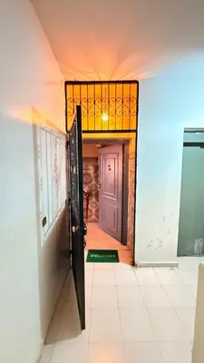 a hallway with a purple door and a tile floor at WOLFY’s Apartment in Marrakech