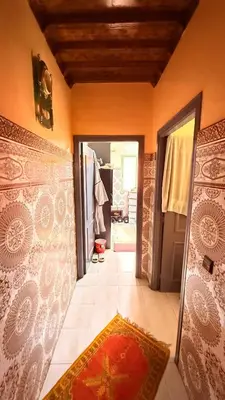 a hallway of a house with a door and a rug at WOLFY’s Apartment in Marrakech
