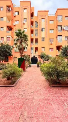 a brick road in front of a large building at WOLFY’s Apartment in Marrakech