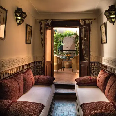 a room with two beds and an open door at Palais Riad Lamrani in Marrakech