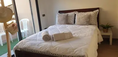 a bedroom with a large bed with towels on it at Appartement gueliz 2 chambres in Marrakech