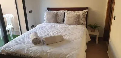 a large white bed with two towels on it at Appartement gueliz 2 chambres in Marrakech