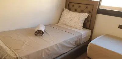 a small bed in a room with a pillow at Appartement gueliz 2 chambres in Marrakech